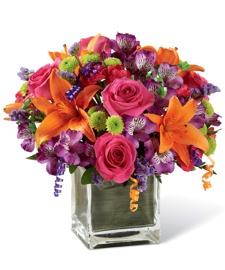 Hot pink roses and orange Asiatic Lilies are vibrant and fun surrounded by purple Peruvian Lilies, hot pink mini carnations, green button poms, purple statice